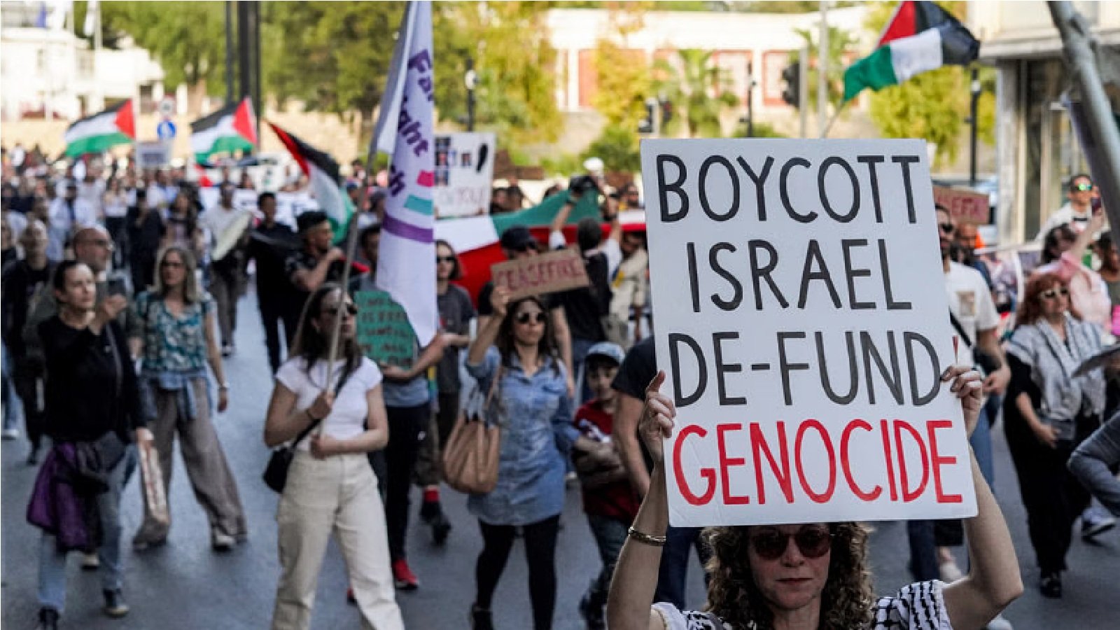A woman marches with a sign condemning Israel with other protesters marching from Eleftheria Square during a demonstration in the southern side of Cyprus' divided capital Nicosia on April 7, 2024 to mark six months of conflict in the Gaza Strip between Israel and the Palestinian militant group Hamas.Photo: AFP