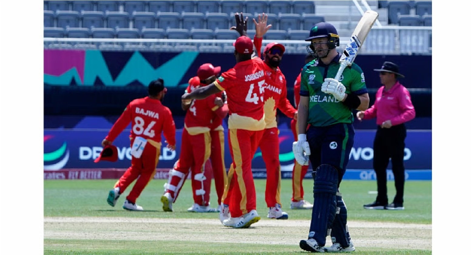 Ireland's Barry McCarthy walks away as Canada celebrates winning the ICC men's Twenty20 World Cup 2024 group A cricket match between Canada and Ireland at the Nassau County International Cricket Stadium in East Meadow, New York, on June 7, 2024. Photo: AFP