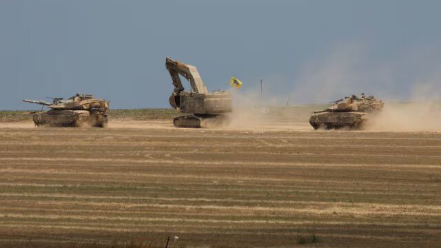 Israeli tanks manoeuvre, amid the ongoing conflict between Israel and the Palestinian Islamist group Hamas, near the Israel-Gaza Border May 14, 2024. REUTERS/Amir Cohen/File Photo