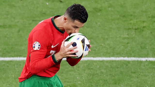 Portugal's Cristiano Ronaldo kisses the ball. REUTERS