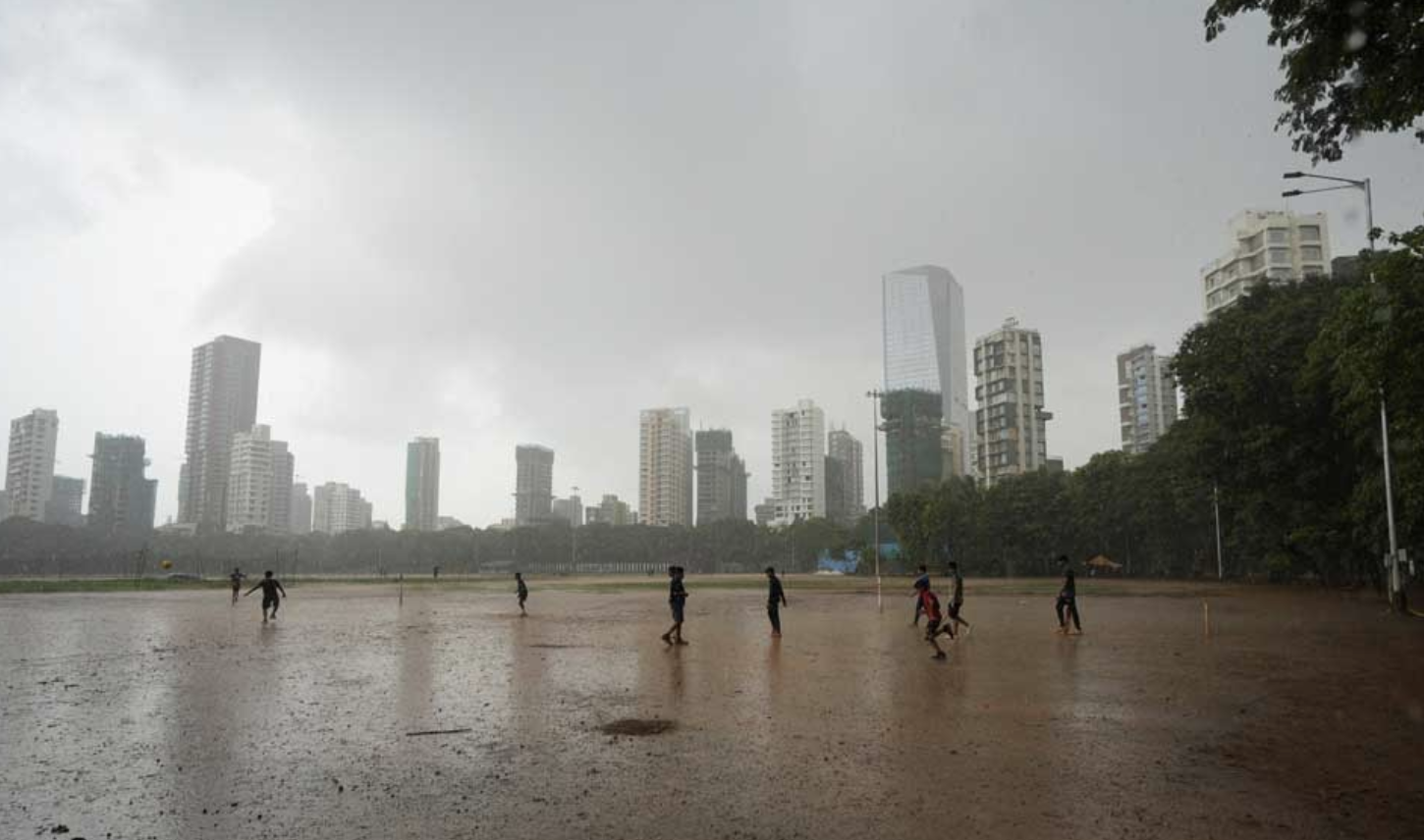 Children play in the rain in Mumbai, India, 20 June, 2024. REUTERS