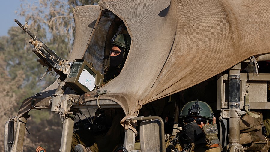 An Israeli soldier gestures while in a military vehicle, amid the Israel-Hamas conflict, near the Israel-Gaza border, in Israel, June 23, 2024. REUTERS/Amir Cohen